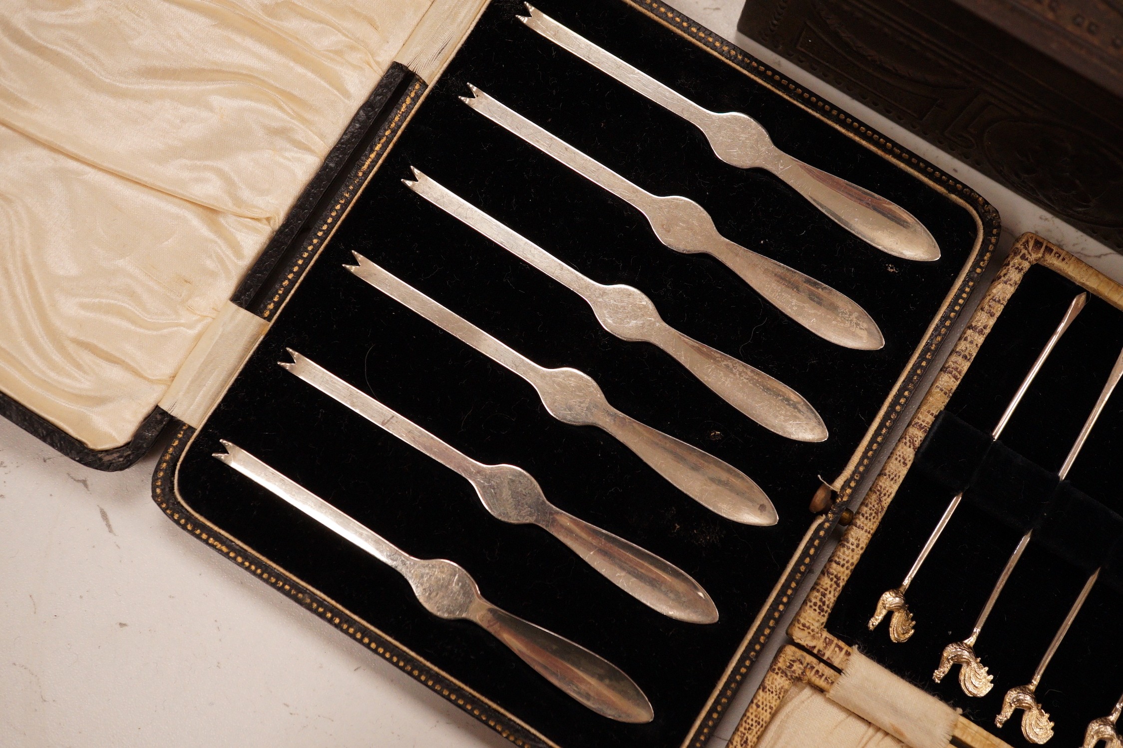 A postal scale, cased silver lobster picks, silver cocktail sticks etc